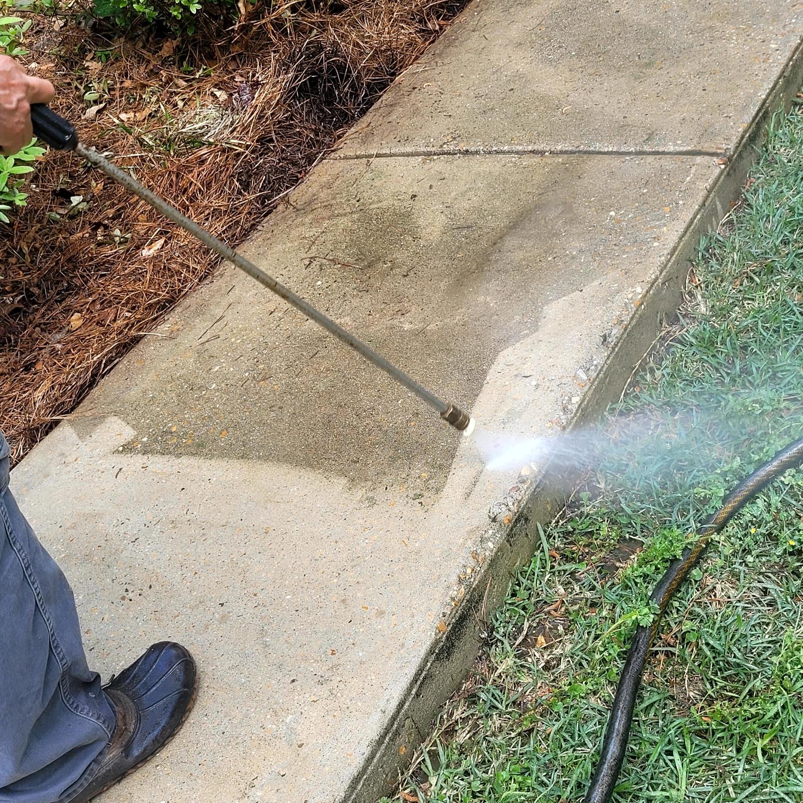 Exterior surface being cleaned with pressure washing